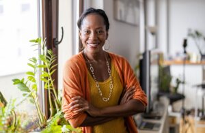 Portrait of a smiling mature woman standing in her apartment